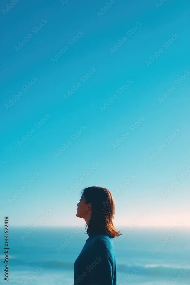 Obraz premium serene coastal scene captures essence of world oceans day with person gazing at ocean horizon