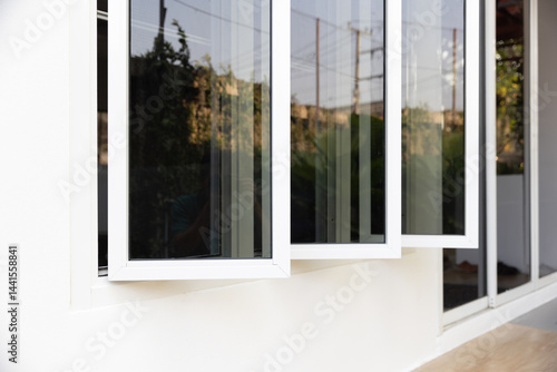 Fotografía Three panel aluminium casement window stay on white wall.