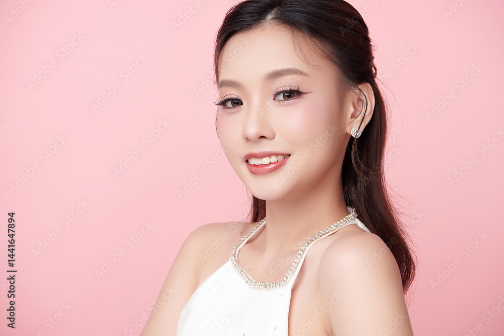 A beautiful young Asian woman with clean, fresh skin against a pink background. Skincare, facial treatment, cosmetology, beauty, and spa. An elegant portrait of an Asian woman. A beautiful young Asian woman with clean, fresh skin against a pink background. Skincare, facial treatment, cosmetology, beauty, and spa. An elegant portrait of an Asian woman.
