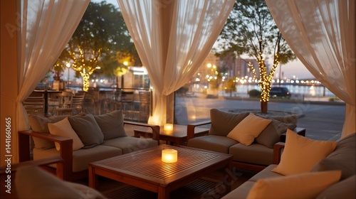 Cozy outdoor patio cafe at twilight with waterfront views. Possible use Stock photo for cafes, restaurants, hospitality advertising, and travel