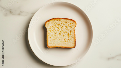 Rustic bread slice centered on a white plate with ample blank space
