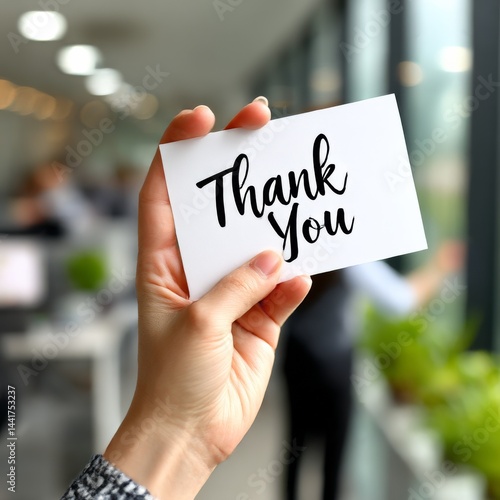 Wallpaper Mural Expressing Gratitude: Woman Holding "Thank You" Card in Office Setting, showing appreciation to colleagues and the work environment. Torontodigital.ca