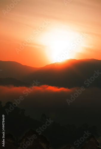 Sunrise over misty mountain range