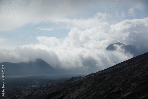 Nature's majesty clouds rolling over mountains remote landscape scenic viewpoint atmospheric wonder