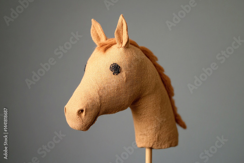 Toy hobbyhorse with a detailed horse head, playful and nostalgic concept, isolated on background, symbol of childhood fun