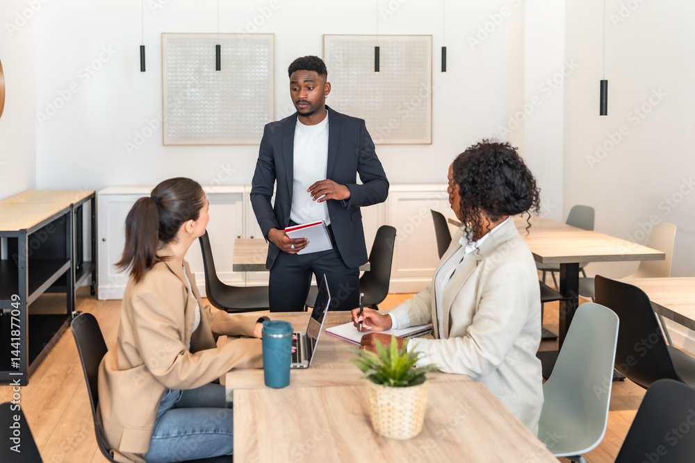 Business team meeting, discussing strategy in modern office space