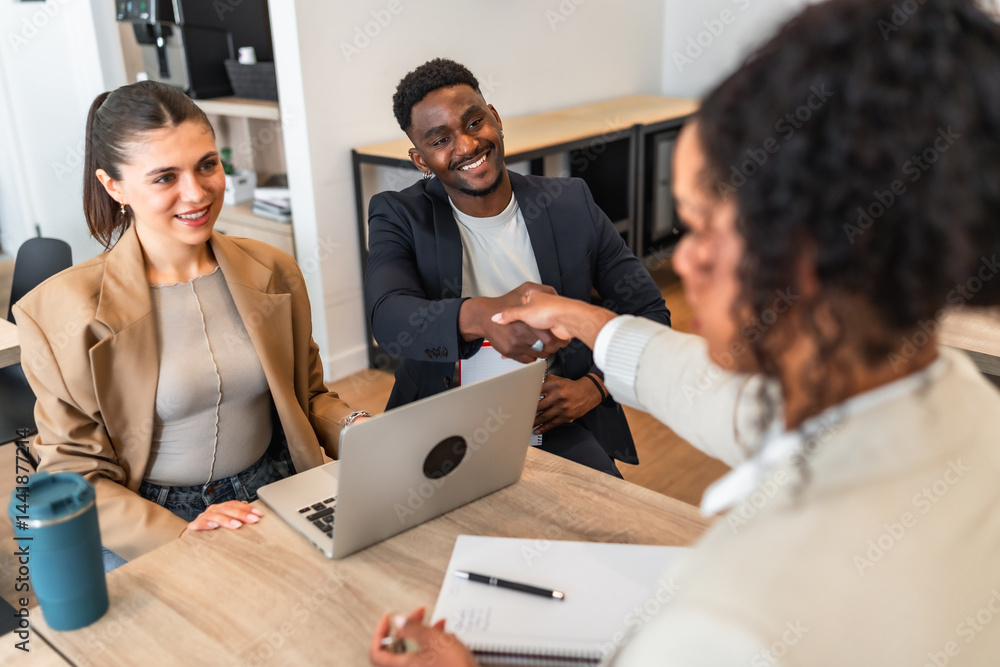 Business people shaking hands during job interview in modern office