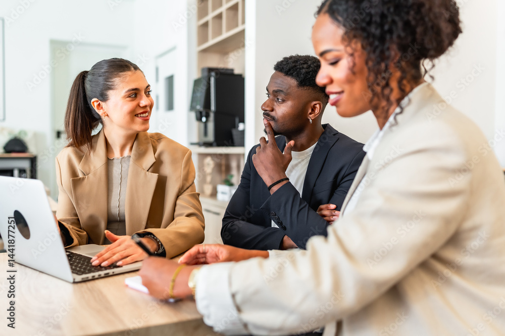 Business people collaborating during meeting using laptop in office