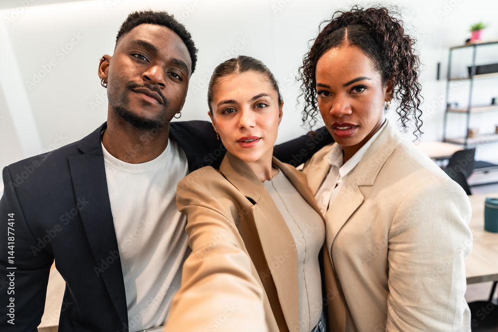 Business team taking selfie in modern office, embracing collaboration and success