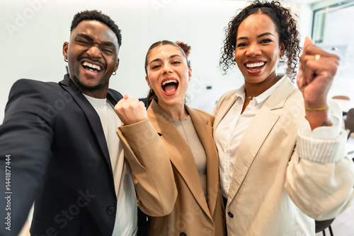 Excited business team celebrating success in office