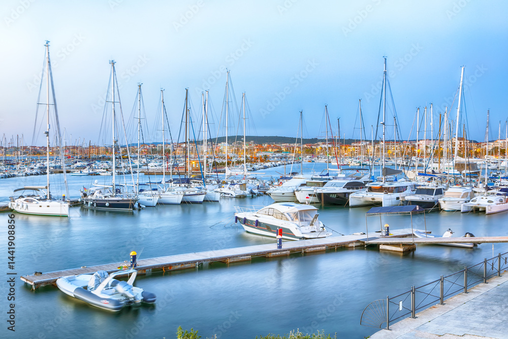 Unbelivable evening view of Alghero port . Mediterranean seascape.