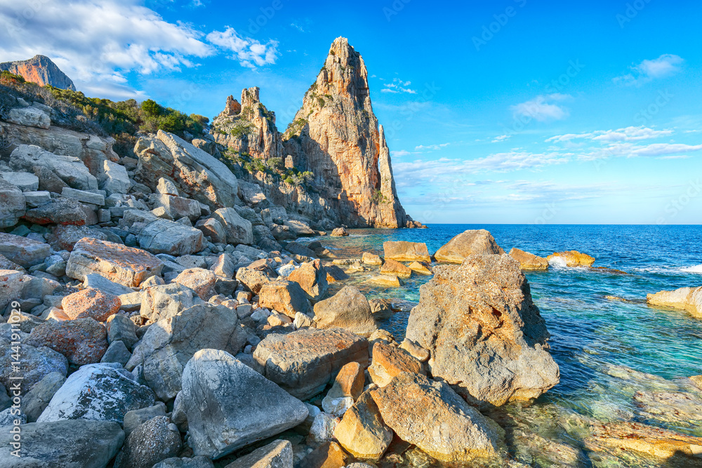 Remarkable view of Punta Pedra Longa and azure water in sea.