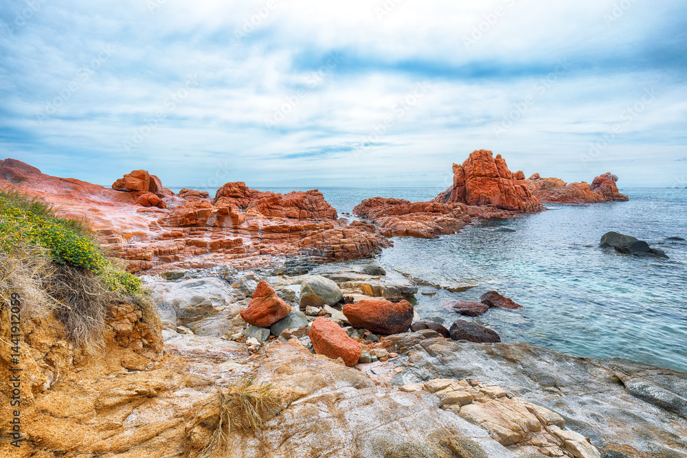 Impressive sunset view of Red Rocks (is Scoglius Arrubius) on Cea beach.