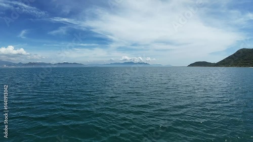 Flying low over ocean at sunrise. Aerial view of drone flight over sea in sunset. 