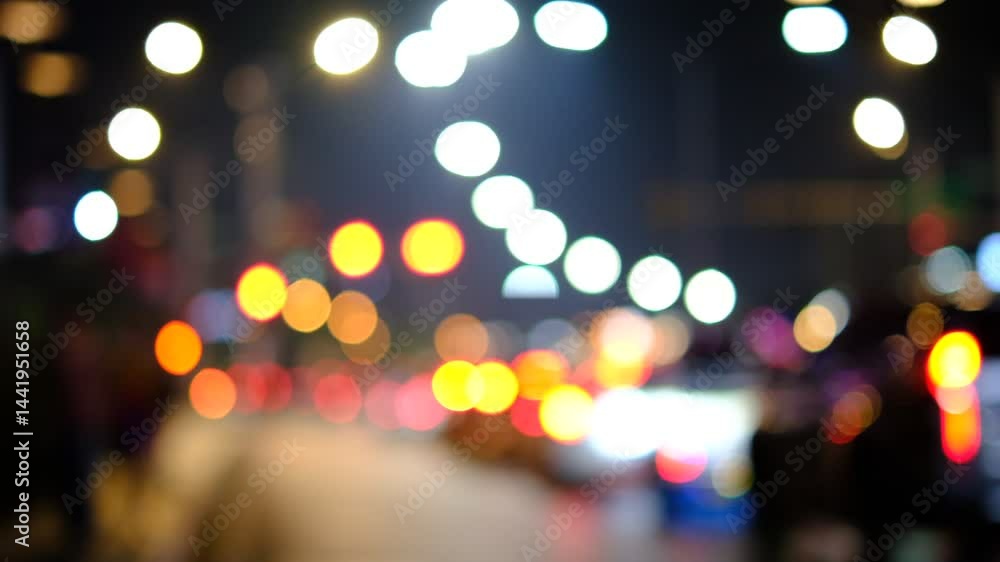 A blurry image of a city street at night with cars and people. The lights from the cars and street lamps create a warm and inviting atmosphere A blurry image of a city street at night with cars and people. The lights from the cars and street lamps create a warm and inviting atmosphere