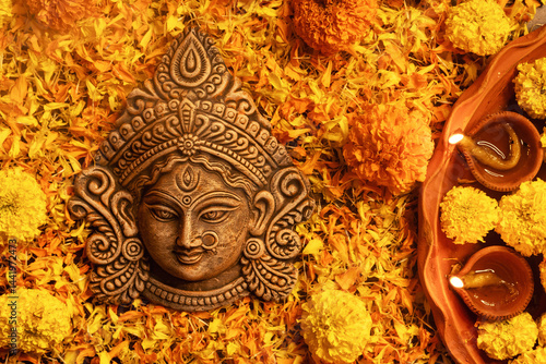 Stunning Goddess Durga with festive marigold flowers and illuminated background.Ideal for Durga Puja, Navratri, Hindu festivals,spirituality, Indian culture, mythology, divine mother, religious events