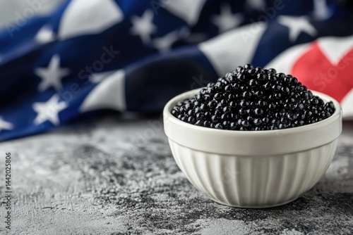 Black Caviar Elegantly Presented in a White Bowl Against a Backdrop of a Colorful Flag