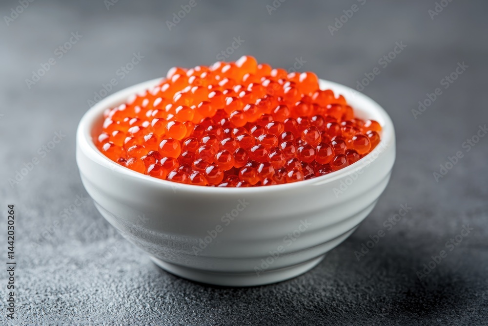 Close-up View of Fresh Red Caviar Served in a White Porcelain Bowl Perfect for Gourmet Dishes and Special Occasions