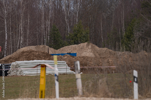 Obraz na płótnie construction equipment on the section of the highway, laying of an underground gas pipeline w salonie