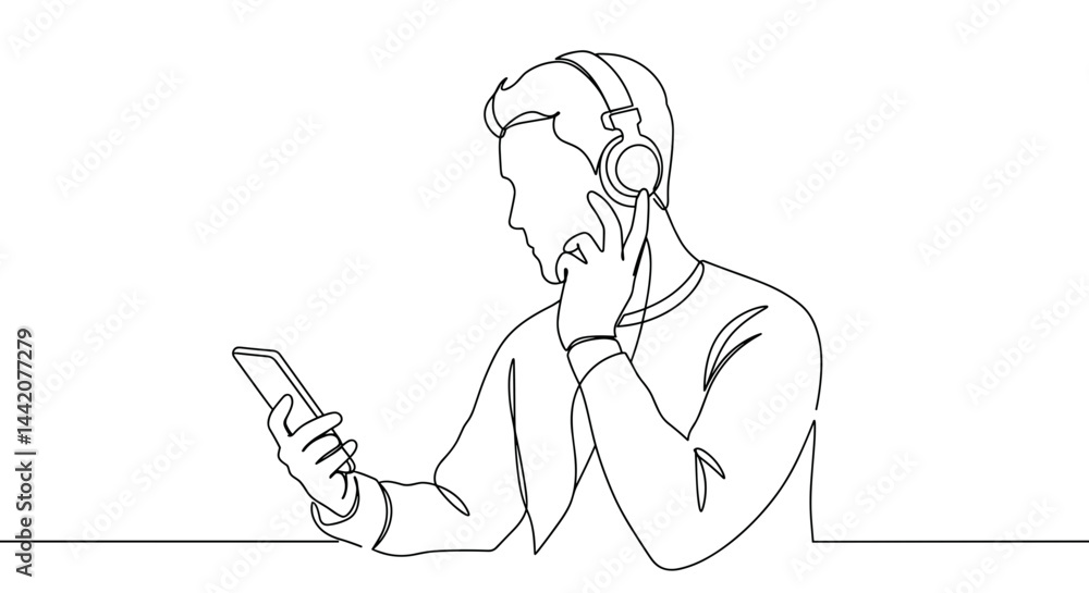 Young man listening to music with headphones while checking phone