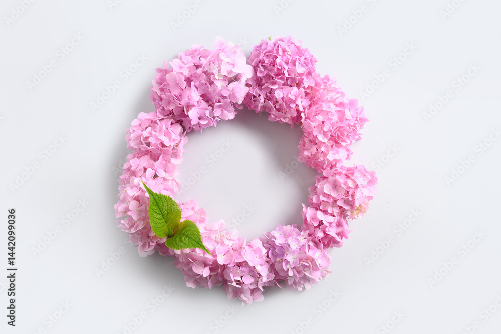 Pink hydrangea flowers as wreath on gray background. Mother's Day Greeting Card. View from above. Space for text.