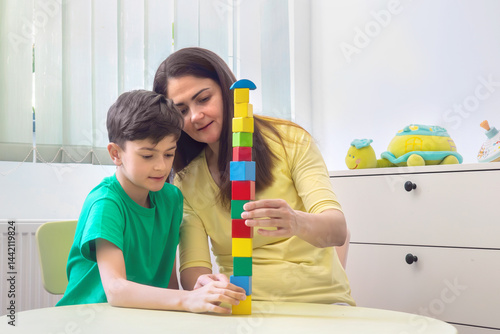 Konstfotografi Child and Therapist Building Block Tower During Developmental Session