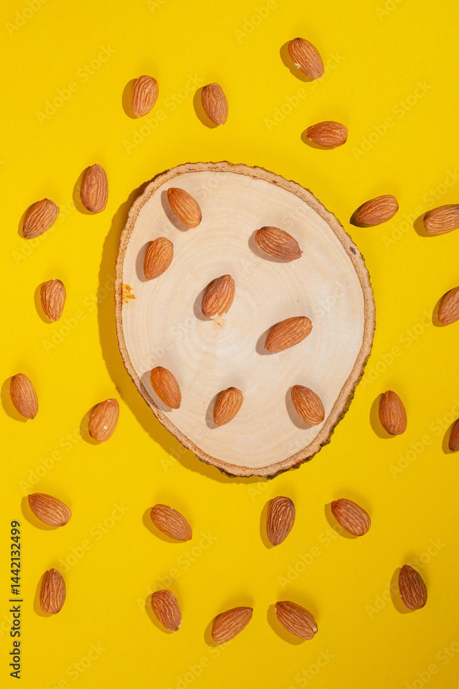 Fototapeta premium Stylish props and almonds seed on yellow background
