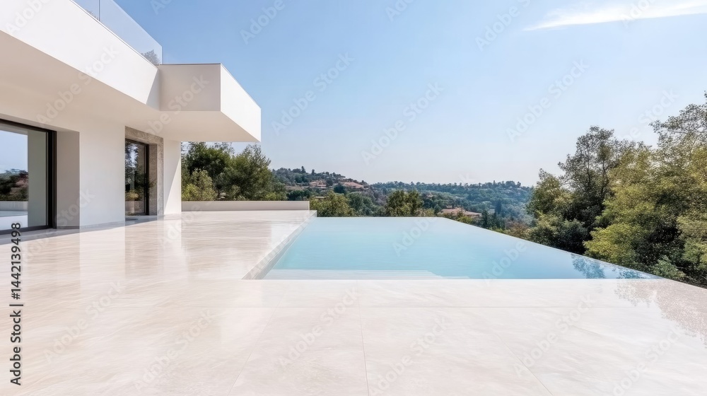 Fototapeta premium Modern minimalist villa terrace with an infinity swimming pool overlooking a green hilly landscape under a clear blue sky.