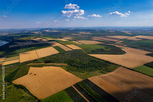 An Aerial View that Captures the Stunning Beauty of Lush Green Fields and a Serene River Landscape
