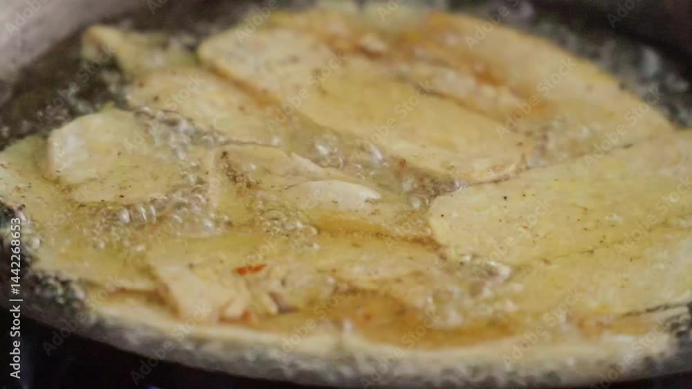Frying sliced tempeh in hot oil, slow motion, closed up Frying sliced tempeh in hot oil, slow motion, closed up