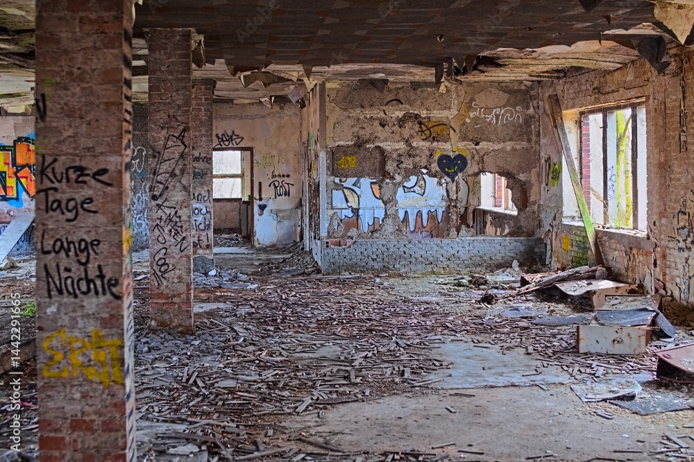 Abandoned brick interior filled with graffiti, fallen debris, and decaying structural walls