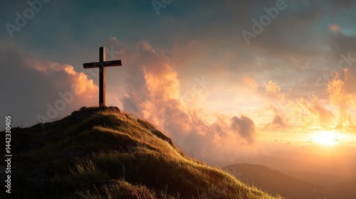 Christian cross standing on a hill during sunrise. Ascension of Jesus concept. Beautiful nature during sunrise or sunset. Cross on top of a hill, Christianity theme.
