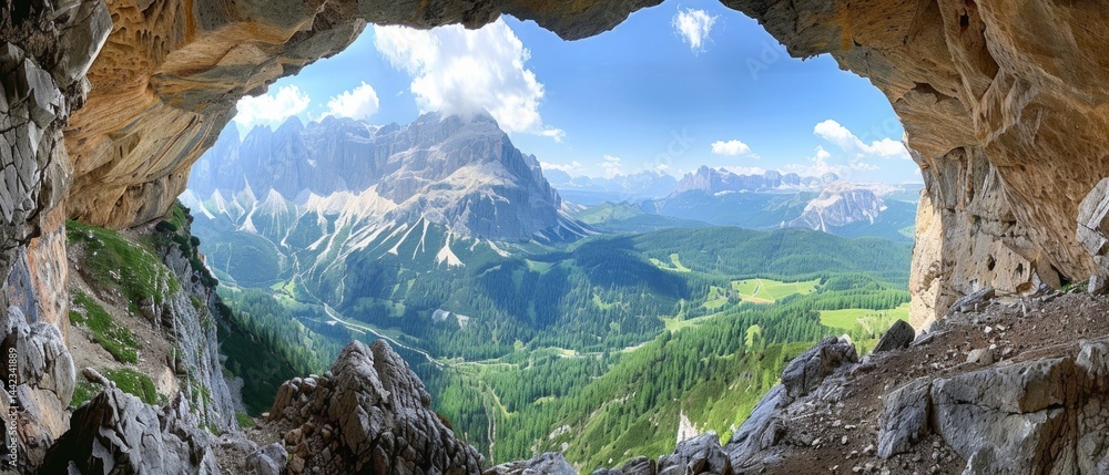 View of mountain landscape with green valleys and snowy peaks through a hole in the rock. Suitable for tourist brochures, advertising of outdoor activities or design of adventure blogs.