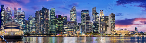 Canvas Print Singapore CBD City Skyline on the river at Sunset with vibrant colours of the high-rise apartment and office towers with the beautiful colours of the sky