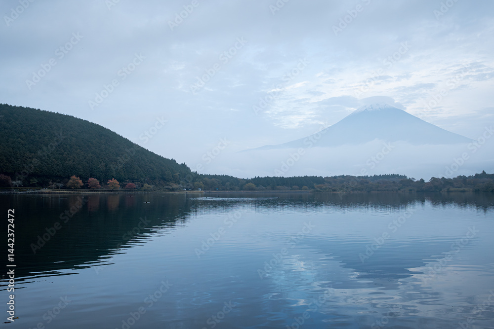 View of Tanuki lake with maple trees in the evening View of Tanuki lake with maple trees in the evening