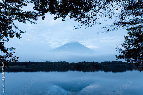 View of Tanuki lake with maple trees in the evening