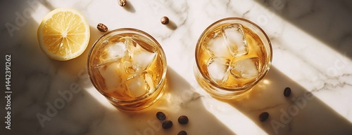 Obraz na płótnie Two glasses of iced whiskey with lemon and coffee beans on marble. w salonie