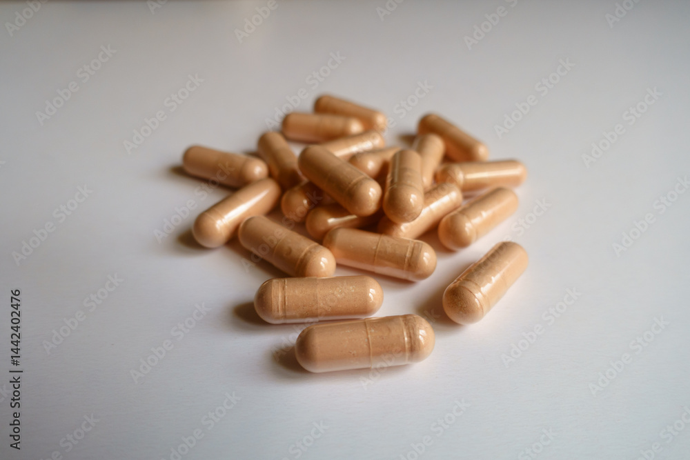 Close shot of heap of pink capsules of palmitoylethanolamide dietary supplement