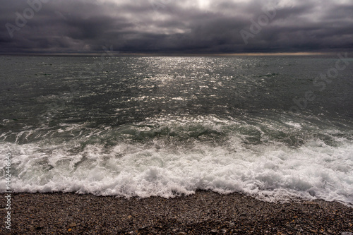 Obraz na płótnie Dark storm clouds over ocean. Dramatic seascape. Clouds and rain flurry over sea. w salonie