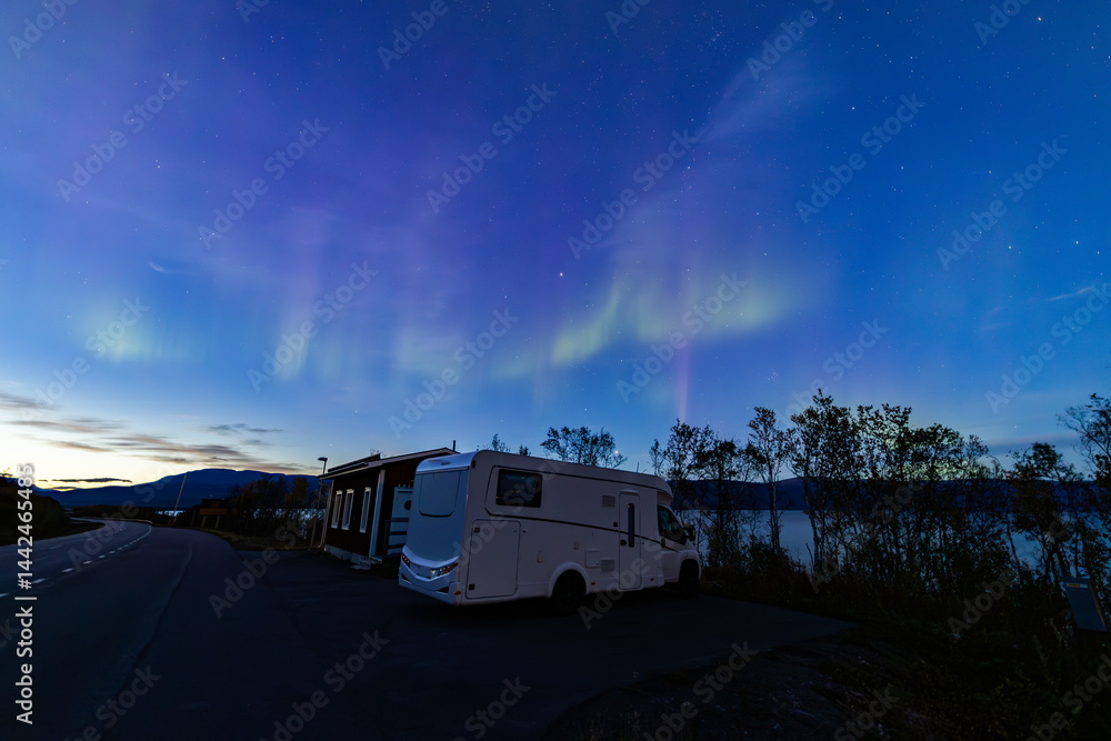 Motorhome and northern lights in Kiruna, Sweden.