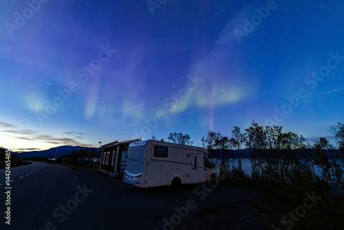 Motorhome and northern lights in Kiruna, Sweden.