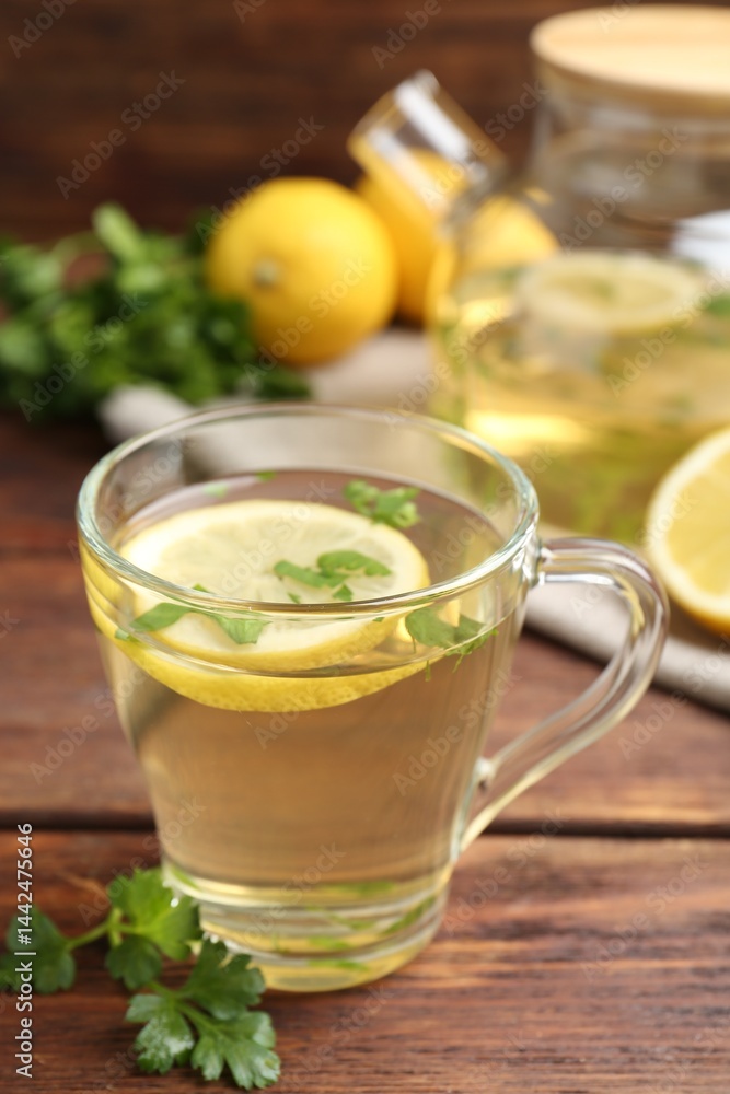 Healthy parsley tea with lemon slices on wooden table. Detox drink Healthy parsley tea with lemon slices on wooden table. Detox drink