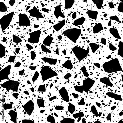 Dense pattern of scattered small black stone-like shapes on a white background creating an abstract look