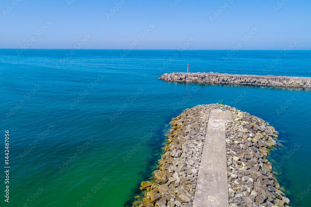 overhead view of powerful waves meeting a concrete block jetty structure, aerial view of large concrete block breakwater with crashing waves overhead view of powerful waves meeting a concrete block jetty structure, aerial view of large concrete block breakwater with crashing waves