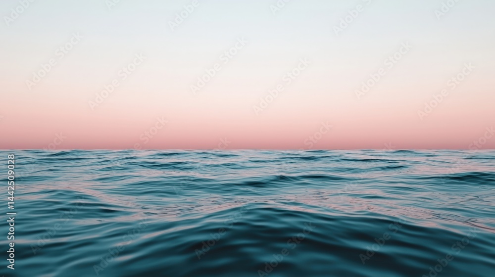Obraz premium Pastel sunset colors reflecting on calm ocean surface