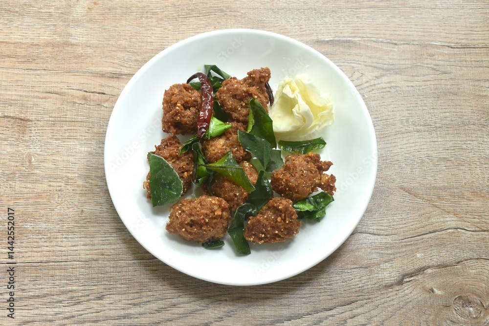 deep fried spicy chop pork ball Thai salad taste spicy and sour with cabbage on plate