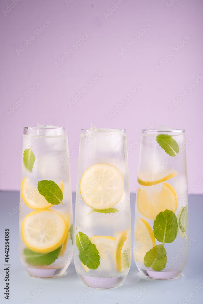 refreshing trio of lemon and mint infused water glasses against pastel lavender background for a cool and inviting summer beverage aesthetic, bright, crisp, colorful, clean, cold, pure, detox refreshing trio of lemon and mint infused water glasses against pastel lavender background for a cool and inviting summer beverage aesthetic, bright, crisp, colorful, clean, cold, pure, detox