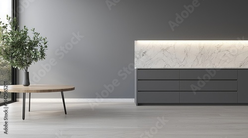 Minimalist modern kitchen interior features grey cabinets, a marble backsplash with warm LED lighting, and a round wooden table with a green plant.