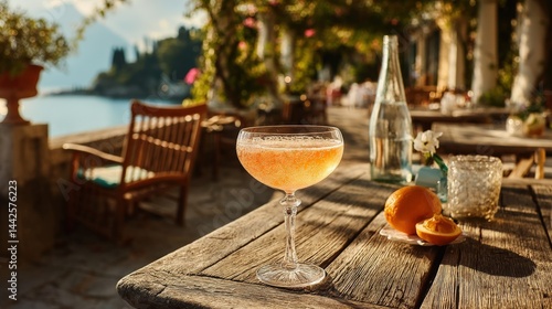 Fototapeta Naklejka Na Ścianę i Meble -  Enjoying a refreshing Bellini on the stunning coast of Sorrento, Italy during sunset