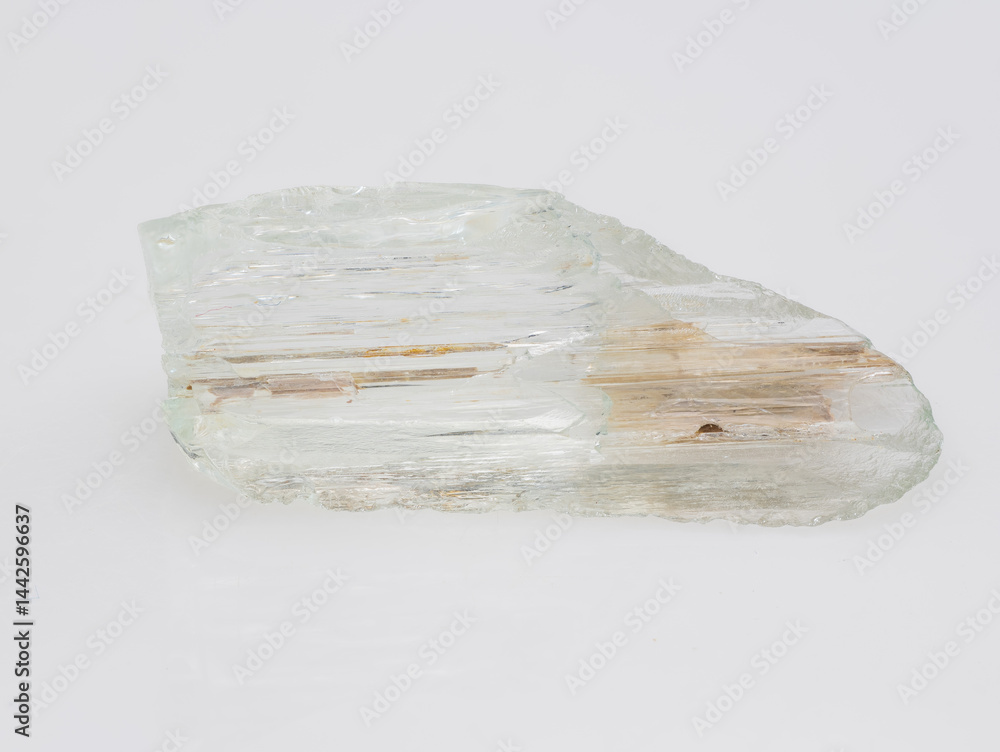 A Roughly Cut Pale Green Beryl Crystal Specimen Exhibiting Schiller Effect, with Visible Inclusions and Parallel Striations, Against a Neutral Light Gray Background
